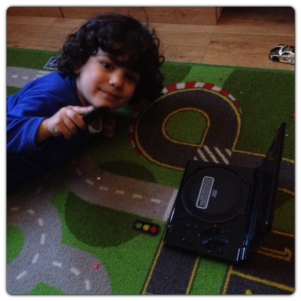 Little Man Enjoying DVD Player at Home