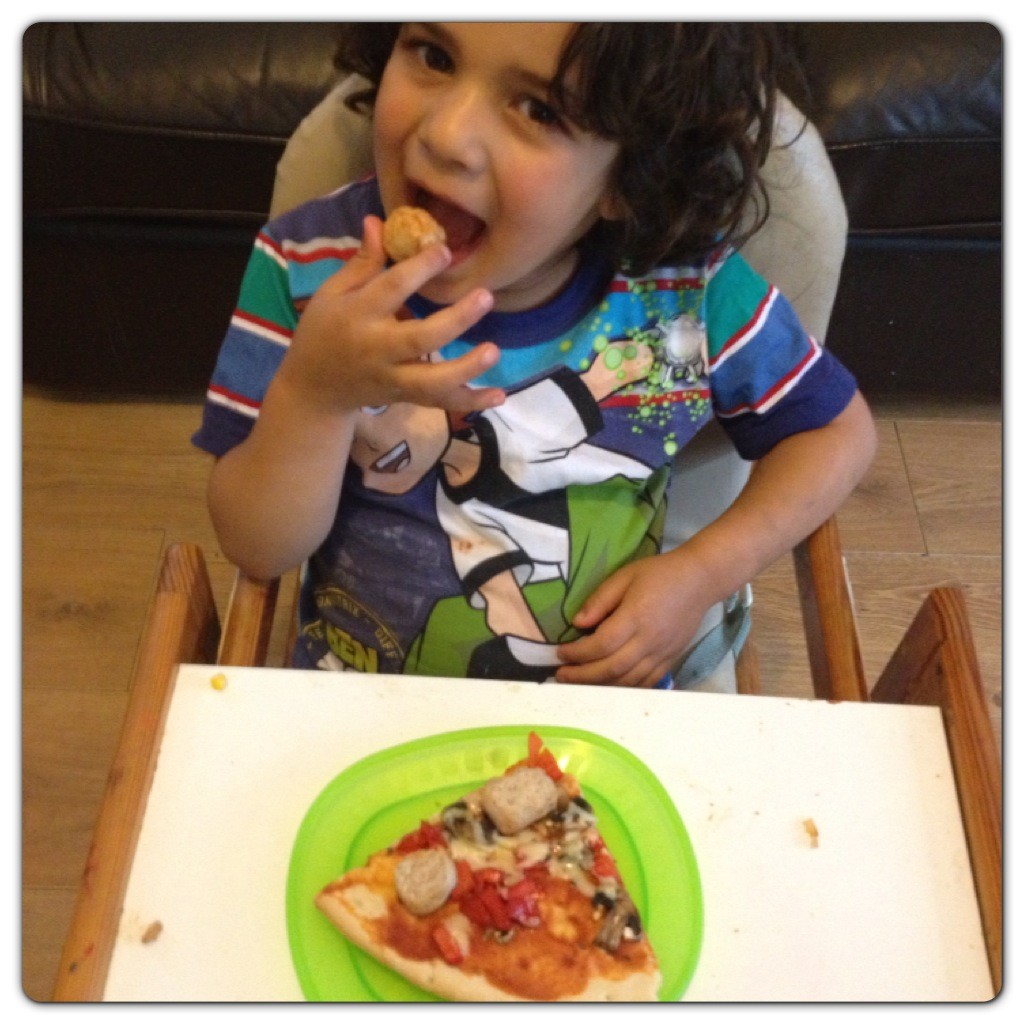 Little Man Enjoying his Pizza