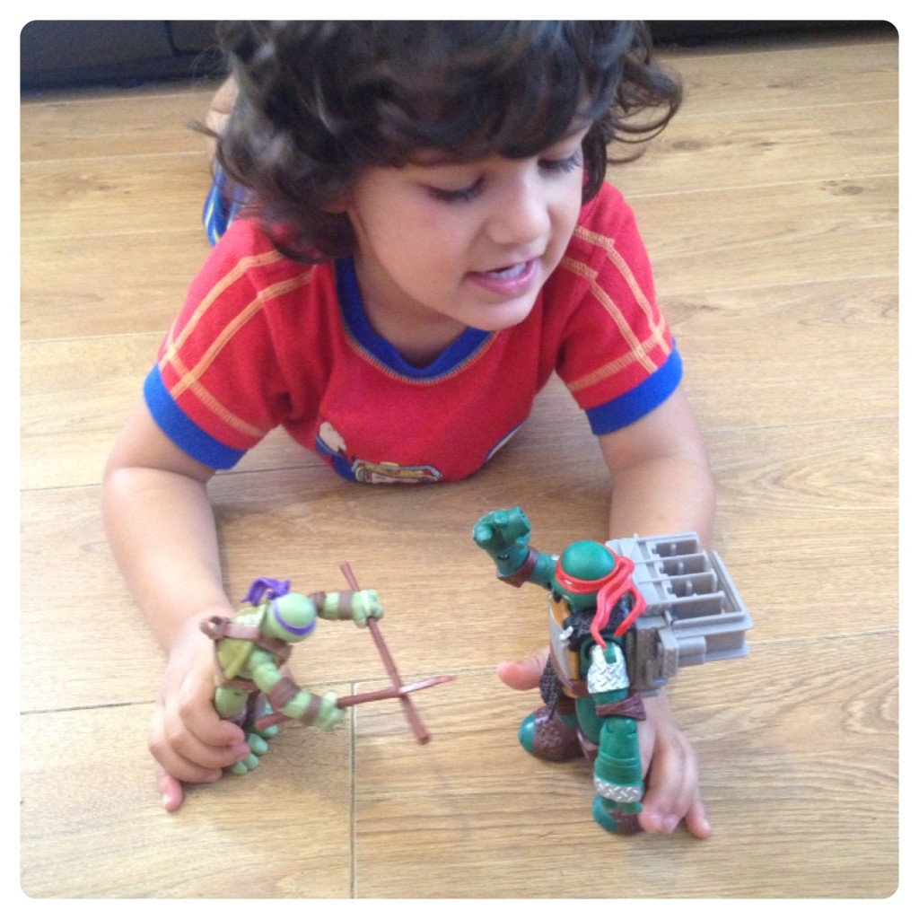 Little Man Playing with Teenage Mutant Ninja Turtles 